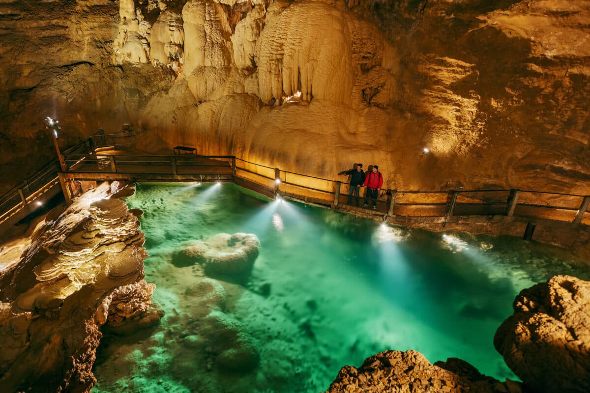 Les eaux turquoise éclairées du Lac Supérieur dans la Salle du Grand Dôme au Gouffre de Padirac.